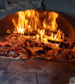 Pizza oven with flame, fire and pizzas. Food cooking scene