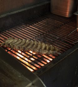 Cooking a rack of ribs on a restaurant's BBQ grill
